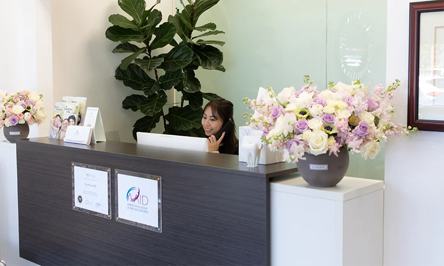 Tan Khuu DDS Front Desk Manager Answering A Phone Call